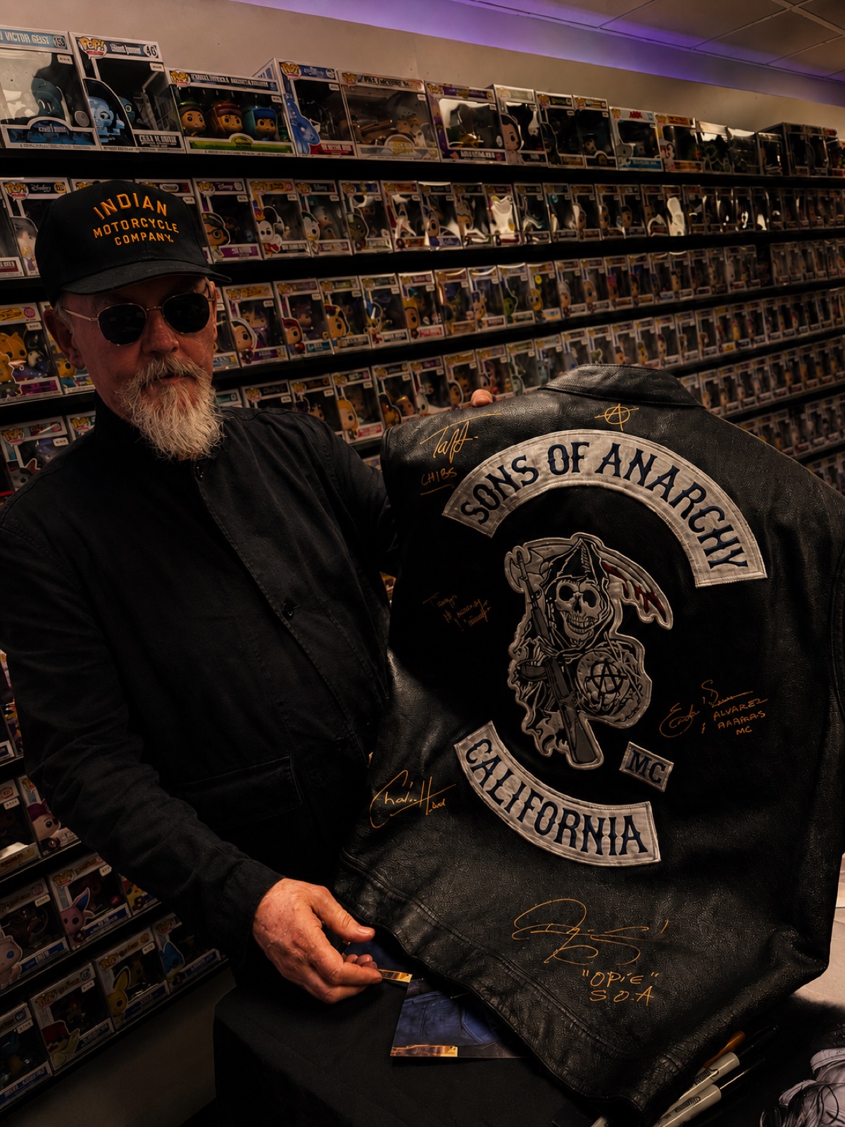 Tommy Flanagan holding a signed Sons of Anarchy jacket during a private signing