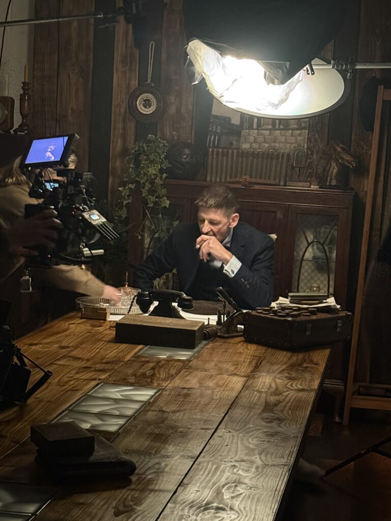 Paul Anderson in character as Arthur Shelby, seated at a desk during the Birmingham City stadium campaign shoot